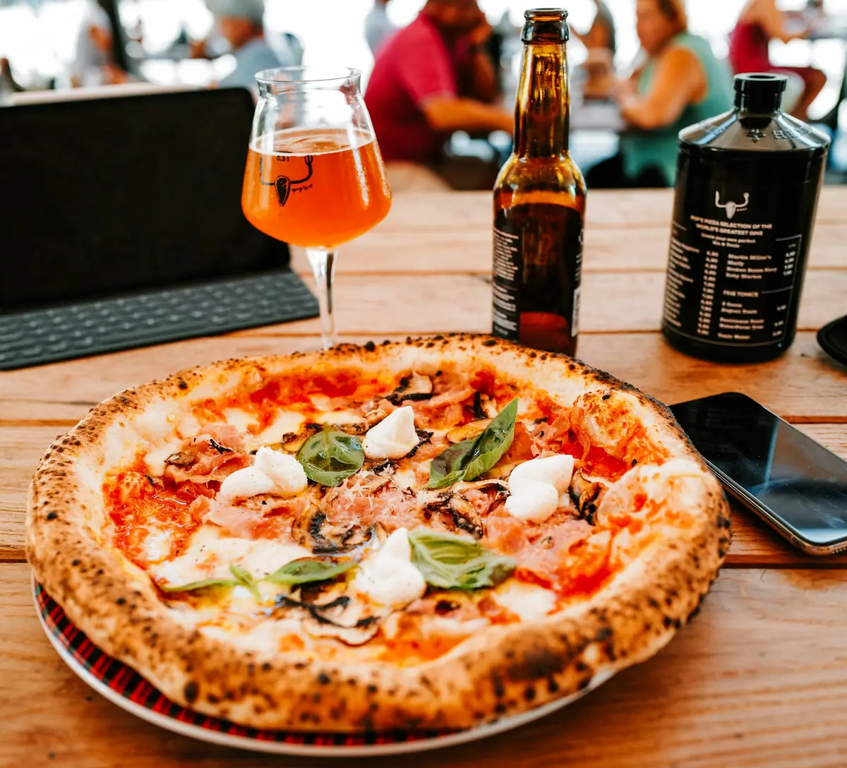 Pizza with fresh toppings on wooden board — whole ingredients, simply arranged